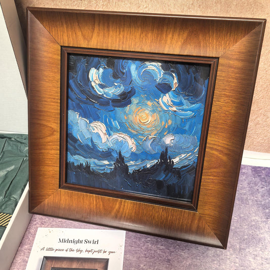 A front-facing view of the "Midnight Swirl" framed art. The square painting depicts a glowing moon and swirling white clouds in a deep blue night sky over a dark silhouette of trees, all encased in a textured dark wood frame.