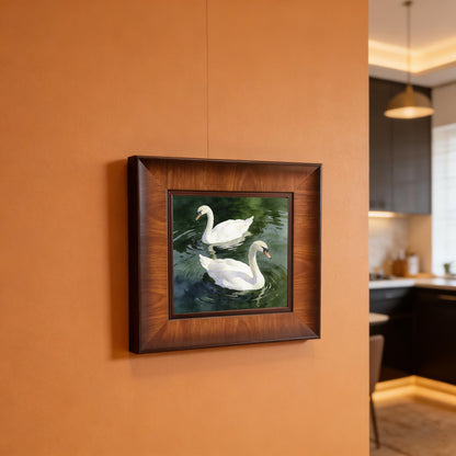 A square swan watercolor art piece in a rich brown wood frame, hanging on a warm terracotta-colored wall in a modern kitchen setting.