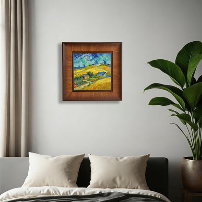 Square wood-framed Van Gogh style landscape painting centered on a minimalist white bedroom wall above a bed with white pillows.