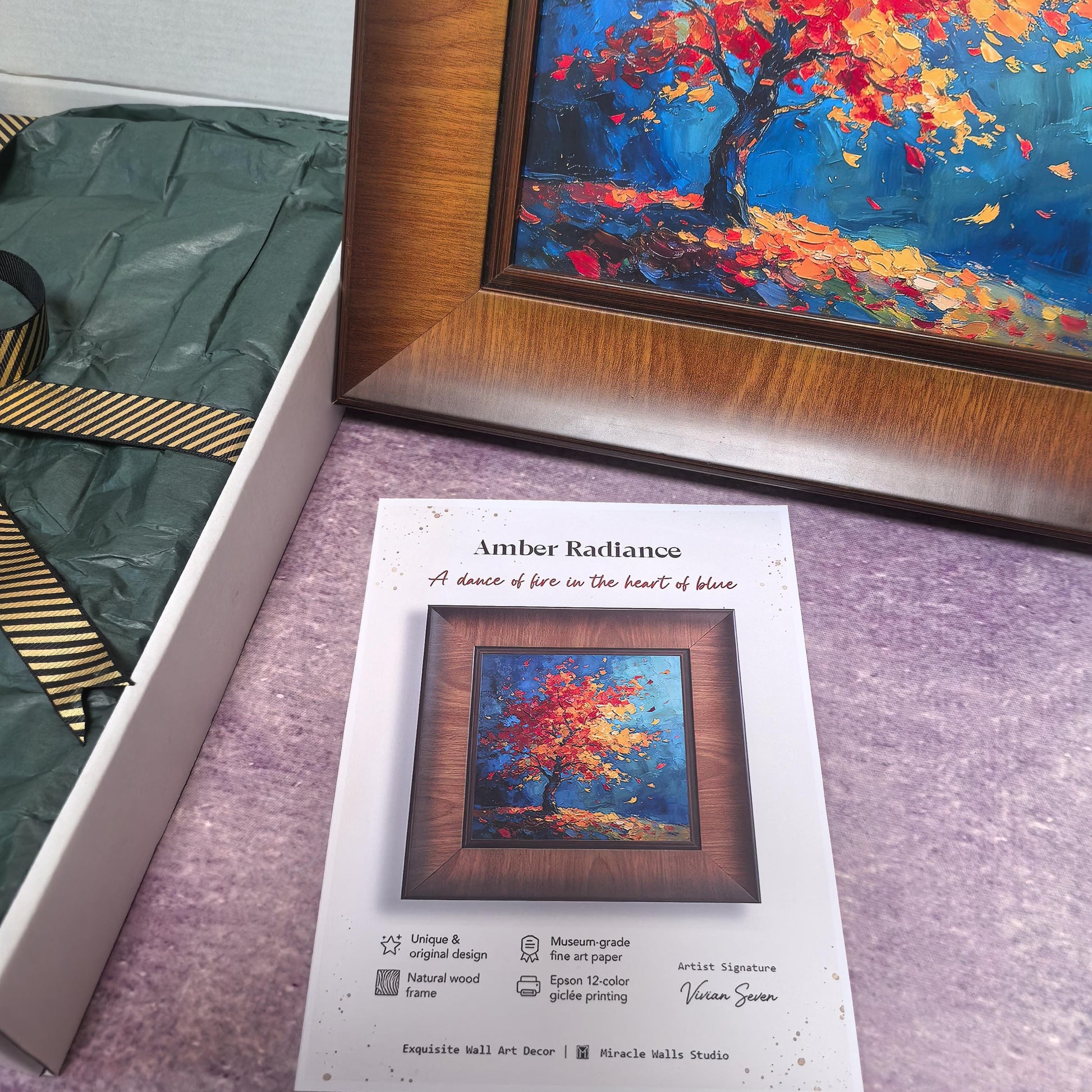 A close-up shot showing the "Amber Radiance" product info card alongside the framed artwork. The card highlights features like "Unique & original design," "Natural wood frame," "Museum-grade fine art paper," and "Epson 12-color giclée printing."